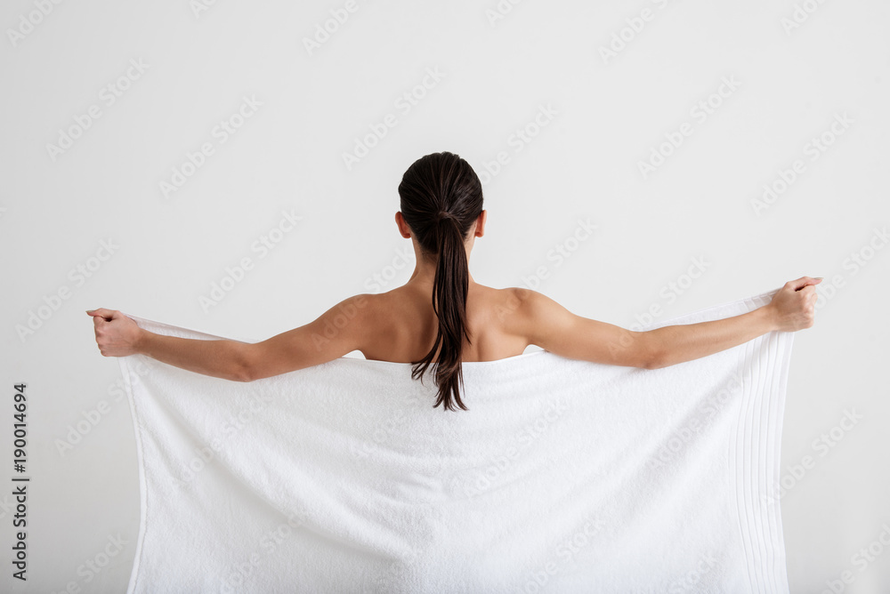 Calm Woman Taking Care Of Her Skin She Is Hiding Fit Naked Body Under Soft Towel Focus On Back