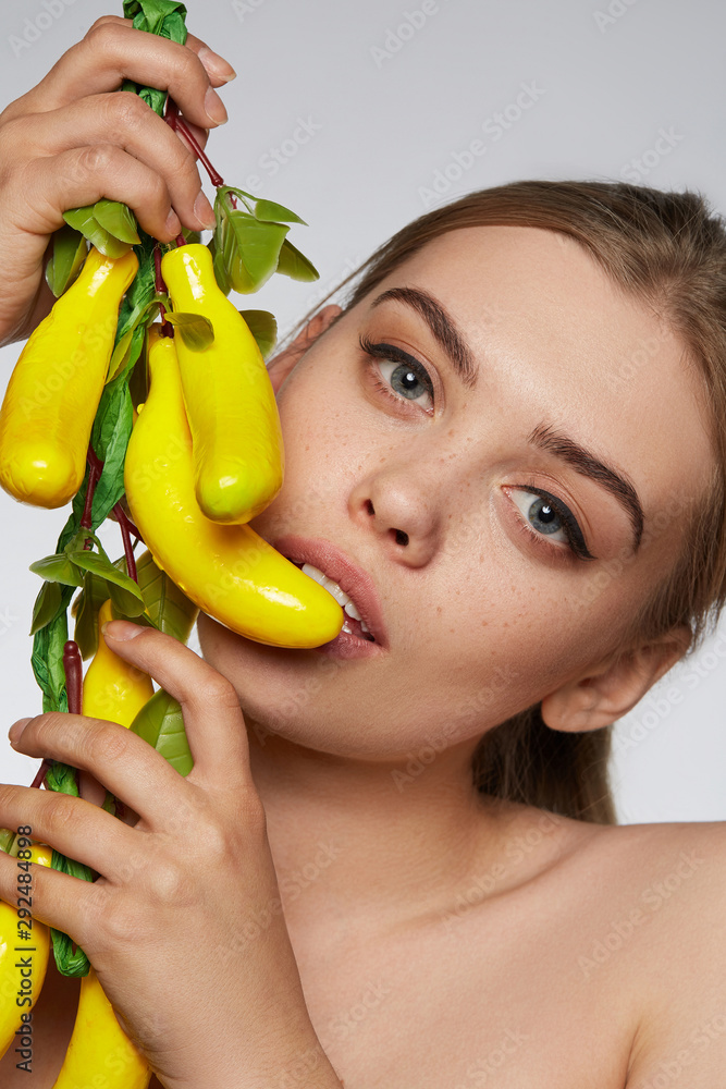 Close Up Portrait Of A Blond Girl With Naked Shoulders She Holding Bunch Of Bananas Near Her