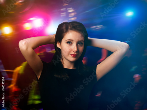 Gorgeous portrait of a girl. Disco, night club. Young girl, teenager. Bright red lipstick, long dark hair. The concept - a way of life of adolescents. Fluorescent colors