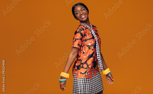 African fashion model on orange background