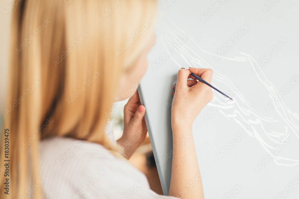 Beautiful Blonde Woman Artist Drawing With A Brush And Pain In Her Art