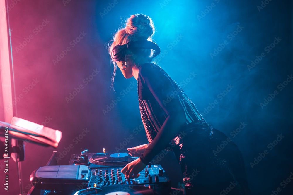 Dj Woman With Blonde Hair Using Dj Mixer And Touching Vinyl Record In