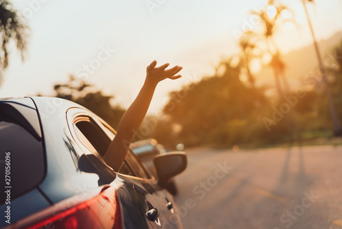 Hatchback Car travel driving road trip of woman summer vacation in blue car at sunset,Girls happy traveling enjoy holidays and relaxation with friends together get the atmosphere and go to destination