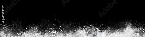Wide design of abstract powder dust explosion over black background