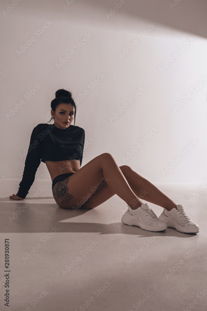 Sexy Hot Woman In Lingerie And Sneakers Posing In Studio On Black