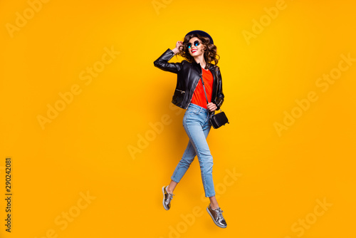 Full length photo of cheerful girl have stroll fun with her friends on spring free time wear good modern look denim jeans isolated over yellow color background
