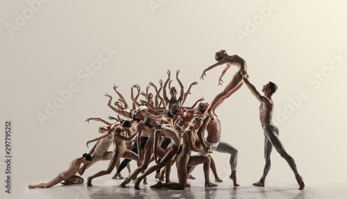 Support. Group of modern ballet dancers. Contemporary art. Young flexible athletic men and women in tights. Negative space. Concept of dance grace, inspiration, creativity. Made of shots of 11 models.