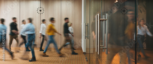 Group of office people walking at office open space. Team of business employees at coworking center. People at motion blur. Concept working at action