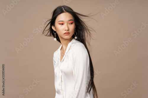 Beautiful elegant woman charm bright makeup beige background Studio Model