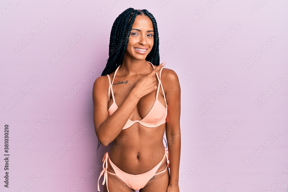 Beautiful Hispanic Woman Wearing Bikini Smiling Cheerful Pointing With Hand And Finger Up To The