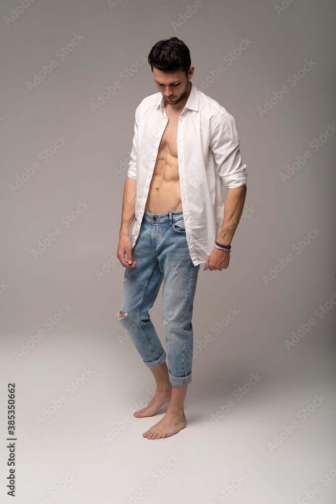 Portrait Of A Well Built Shirtless Muscular Male Model Against White