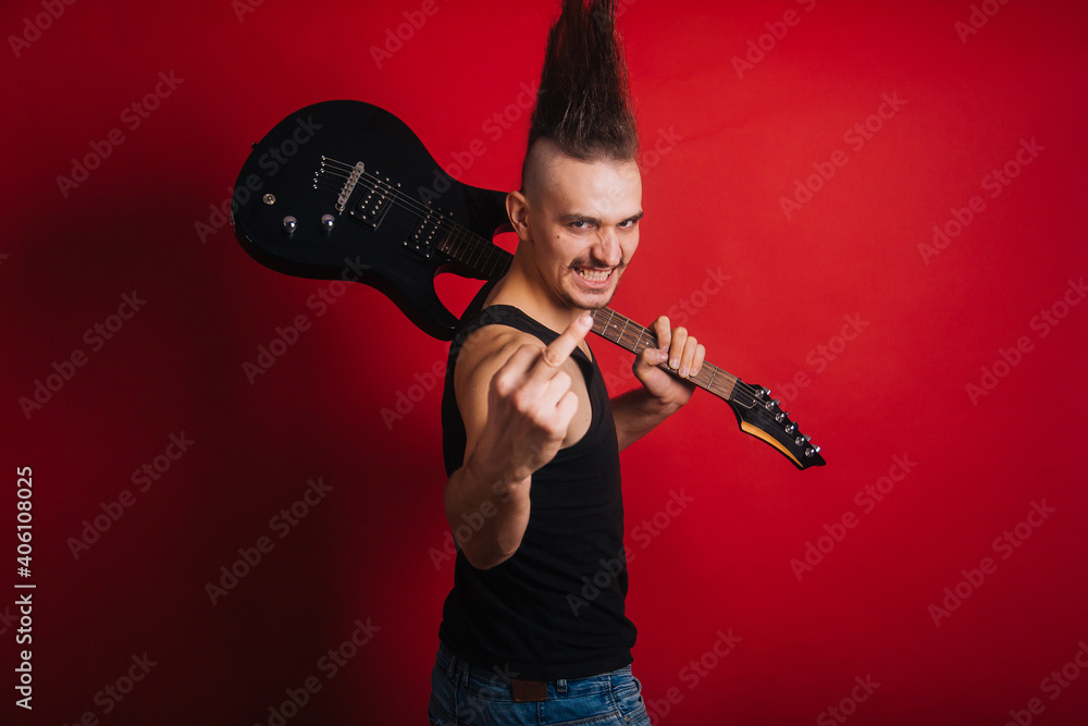 Punk With Black Electric Guitar Mustache And Big Mohawk Shows Fuck Off Gesture Photo Of A Rock