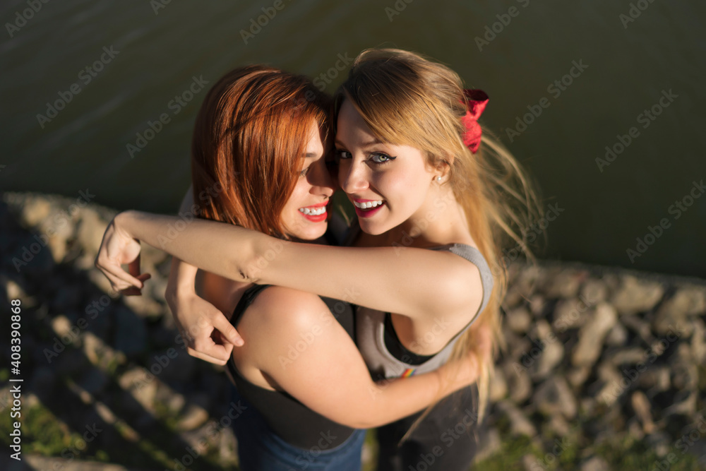 Smiling Lesbian Couple Embracing While Standing By Lake Stock Photo Adobe Stock