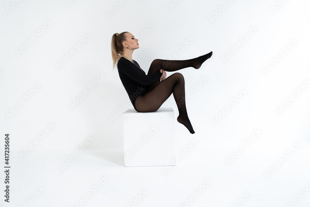 Fashion Model In Black Tights On The White Background Acrobatic Dancing Woman Posing Hot