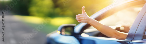 Woman inside her car gesticulate thumb up