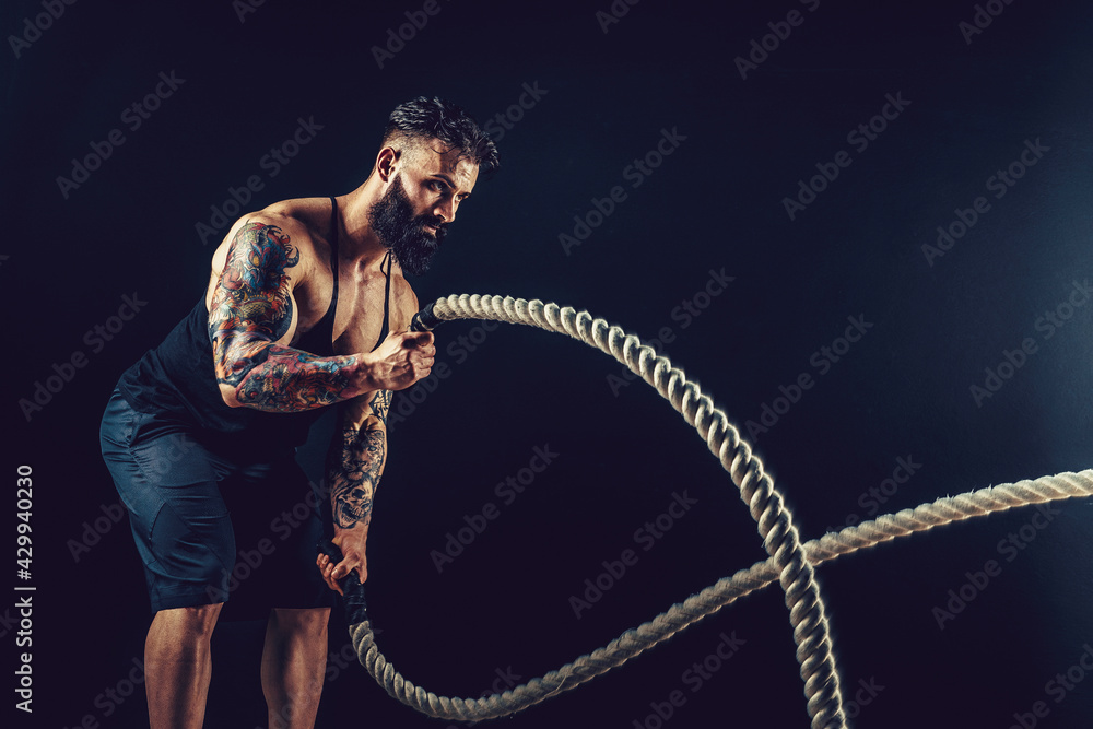 Muscular Man Working Out With Heavy Rope Photo Of Man With Naked Torso Strength And Motivation