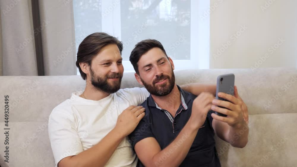 Cute Male Homosexual Gay Couple Spend Time Together On The Couch At Home Men Taking Selfie On