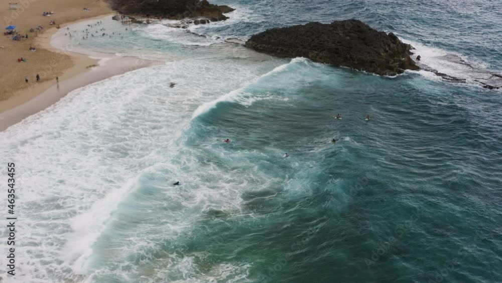 People Swim And Surf At La Poza Del Obispo Beach With Large Waves In