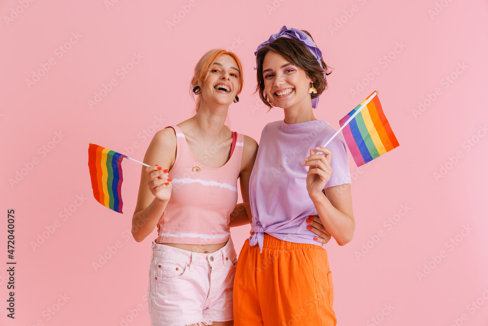 Excited Lesbian Couple Hugging While Posing With Rainbow Flags Stock Photo Adobe Stock