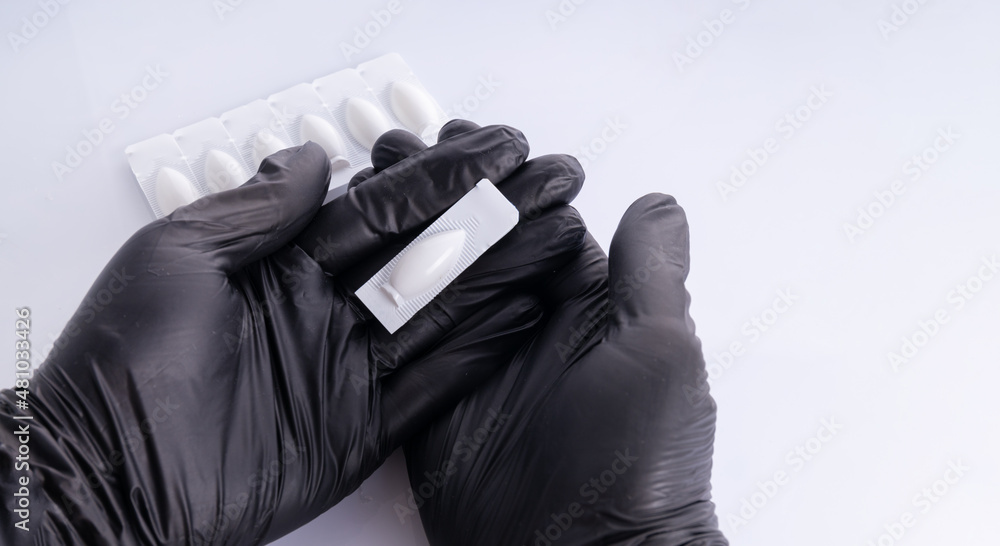 Hands In Black Gloves Opens Suppositories For Anal Or Vaginal Use