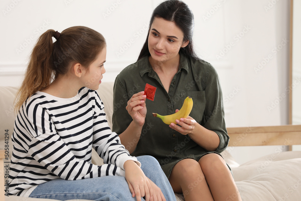 Mother Talking With Her Teenage Daughter About Contraception At Home Sex Education Concept