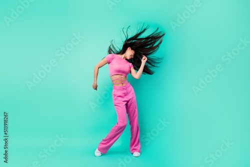 Full body photo of crazy energetic of young lady express herself on dancing floor isolated on teal color background