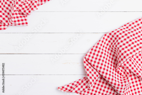 Backdrop for menu of food to restaurants. Red and white fabric tablecloth checkered on wooden white background with copy space. top view, flat lay.