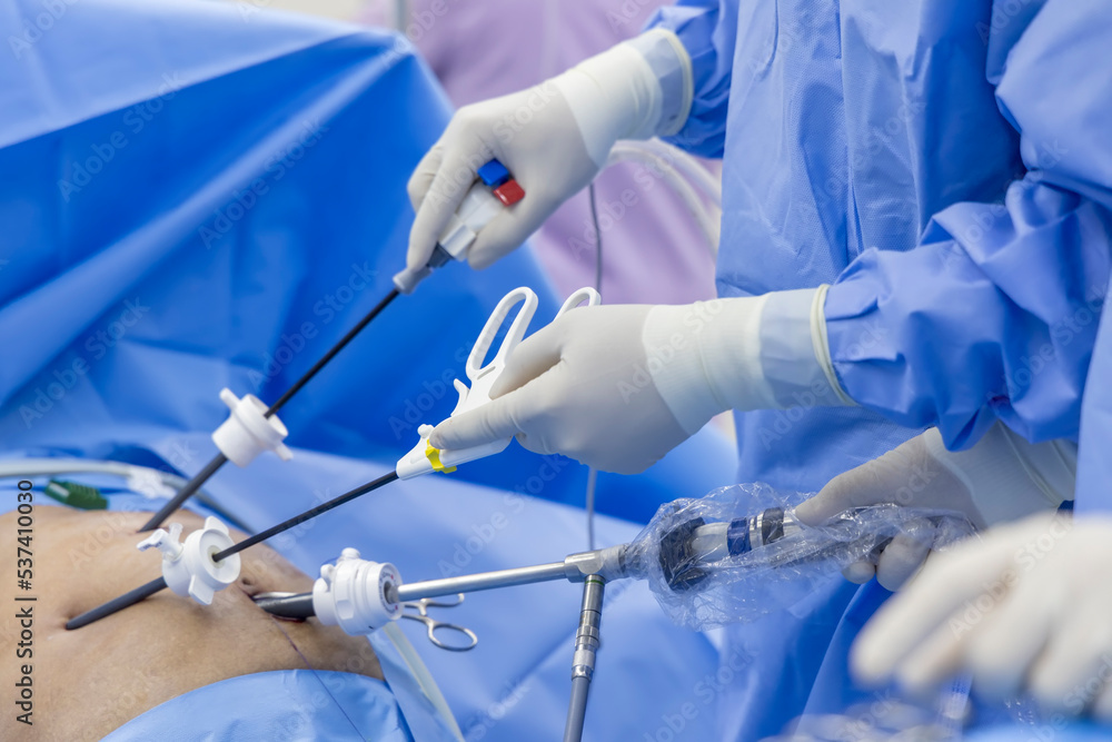 A Doctor In Blue Sterile Surgical Gown Suite Doing Minimal Invasive