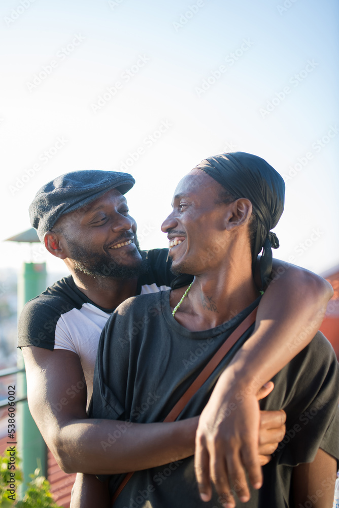 Portrait Of Romantic African Gay Couple Hugging For Photo Two Happy Smiling Men Standing On