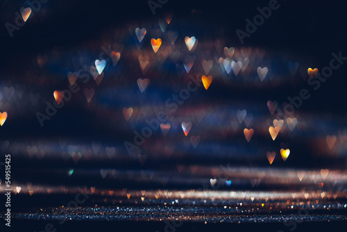 Glowing in the dark colorful heart shaped bokeh lights. Valentine's Day texture background