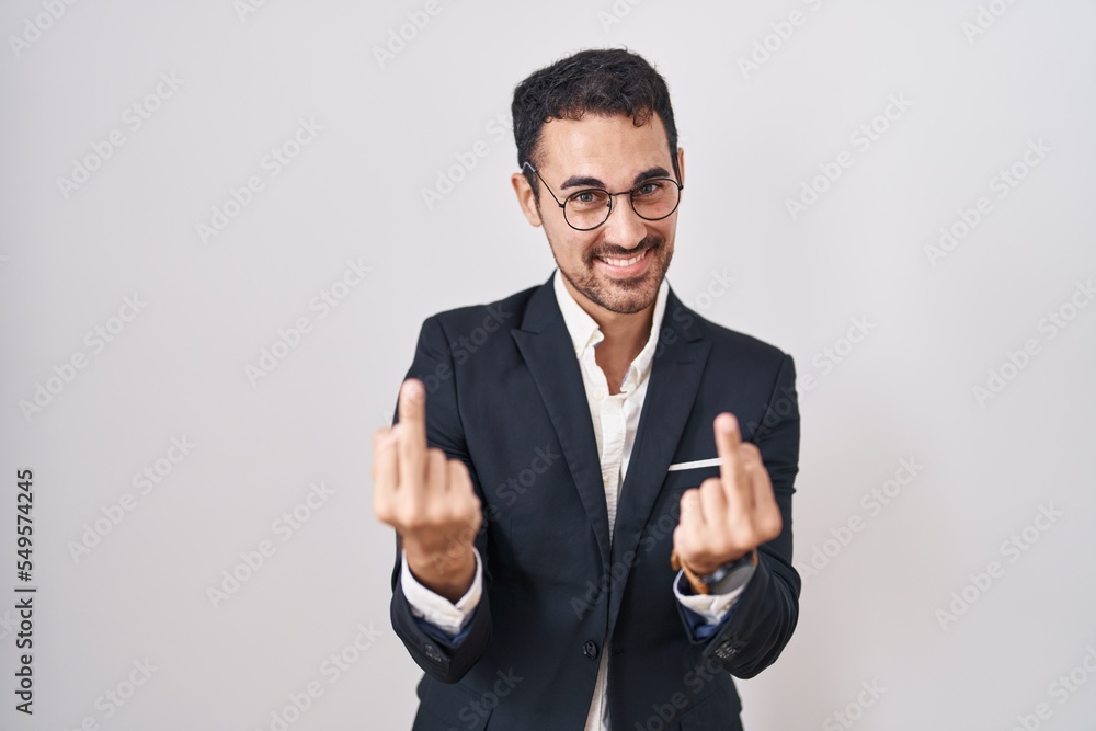 Handsome Business Hispanic Man Standing Over White Background Showing Middle Finger Doing Fuck