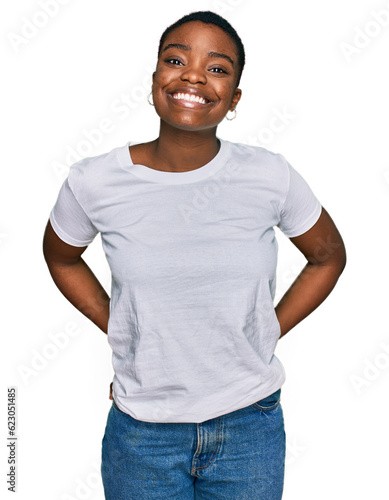 Young african american woman wearing casual white t shirt with a happy and cool smile on face. lucky person.