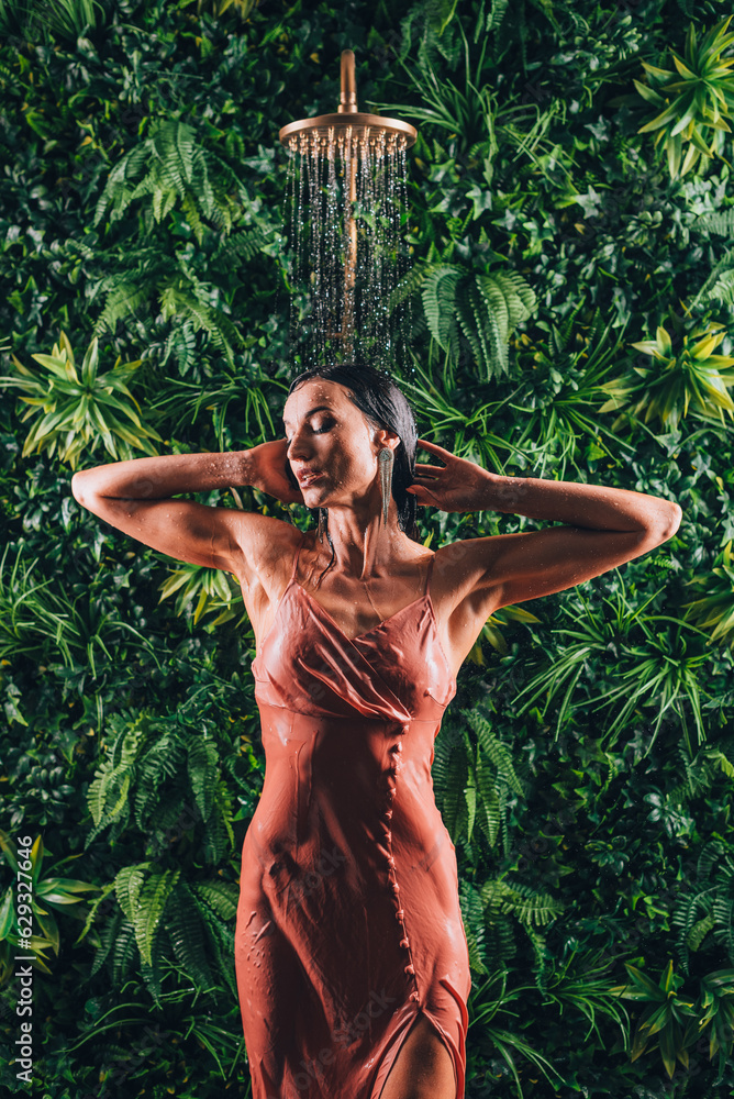 Sexy Woman Body In A Dress Takes A Tropical Shower Against The Backdrop Of Green Tropical