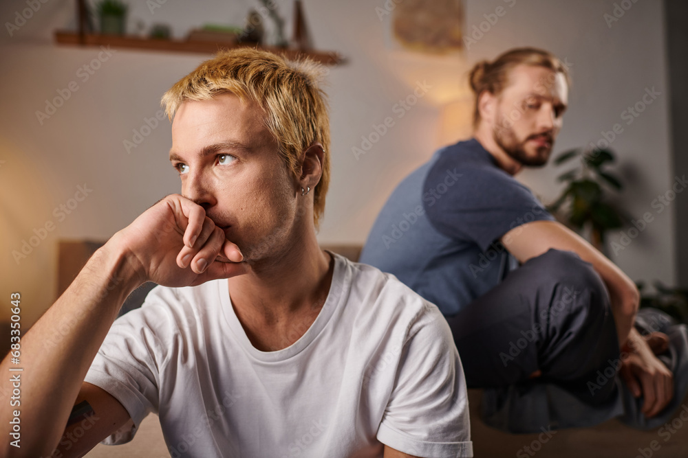Offended Gay Couple Sitting In Silence In Bedroom At Night Troubled Love And Misunderstanding