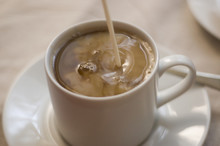 Pouring Cream Into Coffee