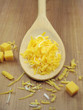 grated cheese on wooden spoon