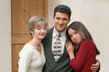 happy family in front of the home