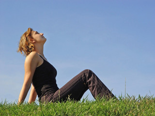 beautiful woman sitting in the grass