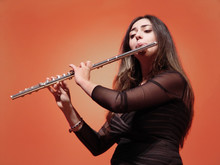 Beautiful Girl Playing Flute At The Concert