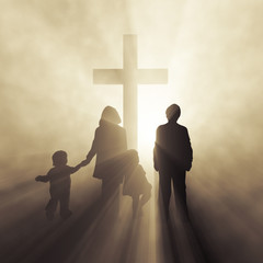 family standing in front of a glowing cross