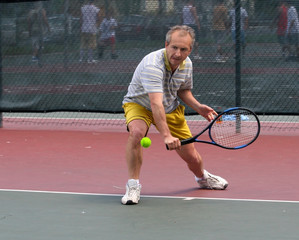 middleage man playing tennis