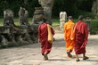  a group of monks leave one of the angkor temples