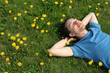 © pikselstock - young man lying on the grass