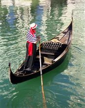 Gondola And Gondolier On The Water
