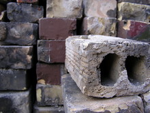 Stack Of Old Bricks With A Brick In The Foreground