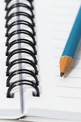 empty blank ring, spiral notepad, blue pencil