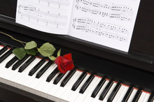 Sheet Music With Rose On Piano