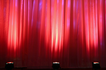 spot lights on red curtain