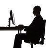 silhouette of man working computer