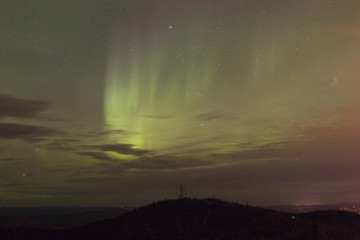 Wall Mural - vivid aurora borealis through clouds